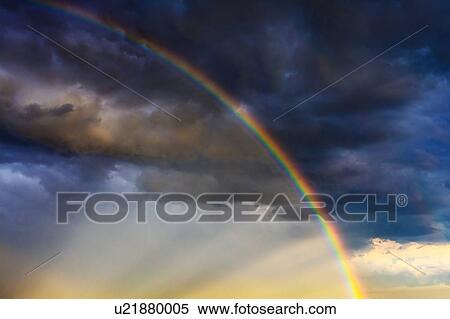Stock Photography - Multi colored dramatic sky with rainbow. Fotosearch