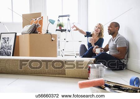 Multi ethnic couple in new apartment View Large Photo Image Stock Image - Multi ethnic couple in new apartment. Fotosearch
