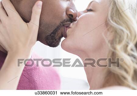 Multi ethnic couple kissing View Large Photo Image Stock Image - Multi ethnic couple kissing. Fotosearch