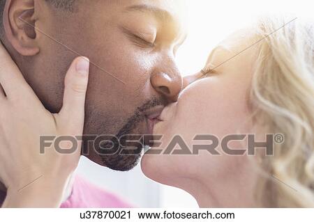 Multi ethnic couple kissing View Large Photo Image Stock Image - Multi ethnic couple kissing. Fotosearch