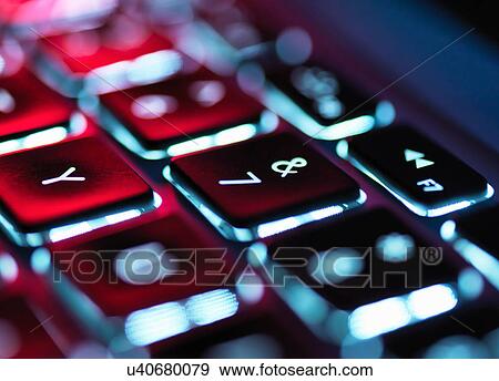 Stock Photo - Night-lit laptop computer focusing on the keyboard. Fotosearch