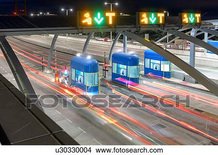 Picture - Night view of cars passing through toll booth at bridge, high angle. Fotosearch