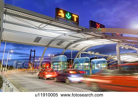 Night view of cars passing through toll booth at bridge View Large Photo Image Stock Photography - Night view of cars passing through toll booth at bridge. Fotosearch