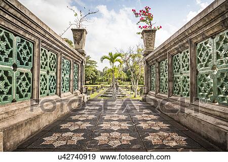 Stock Photo - Ornamental stone walkway and formal garden, Amlapura, Bali, Indonesia. Fotosearch