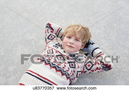 Overhead portrait of boy lying on frozen lake, Gavle, Sweden View Large Photo Image Stock Photo - Overhead portrait of boy lying on frozen lake, Gavle, Sweden. Fotosearch