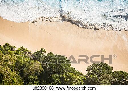 Stock Photo - Overhead view of beach and ocean waves, Peluwang, South Coast, Nusa Penida, Indonesia. Fotosearch
