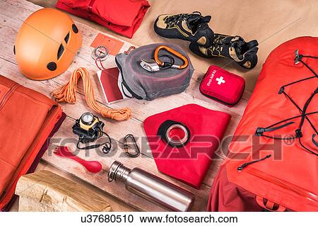 Stock Image - Overhead view of climbing equipment packing with first aid kit, climbing helmet, rucksack and climbing ropes. Fotosearch