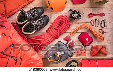 Stock Photo - Overhead view of climbing equipment with climbing helmet, first aid kit, climbing boots and climbing ropes. Fotosearch