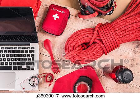 Overhead view of climbing equipment packing with red first aid kit, climbing ropes and laptop View Large Photo Image Stock Photo - Overhead view of climbing equipment packing with red first aid kit, climbing ropes and laptop. Fotosearch