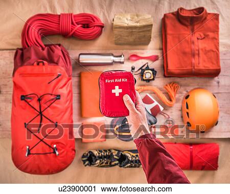 Overhead view of man's hand holding first aid kit above climbing equipment packing with climbing helmet, rucksack and climbing ropes View Large Photo Image Stock Image - Overhead view of man's hand holding first aid kit above climbing equipment packing with climbing helmet, rucksack and climbing ropes. Fotosearch