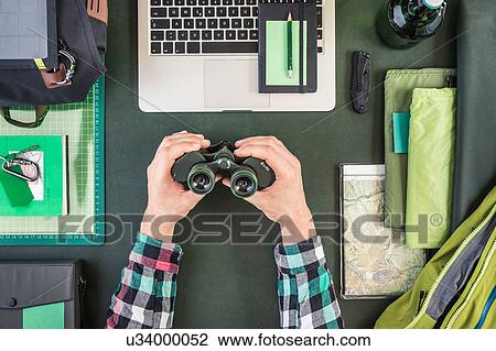 Overhead view of man's hand holding binoculars whilst preparing hiking equipment View Large Photo Image Stock Image - Overhead view of man's hand holding binoculars whilst preparing hiking equipment. Fotosearch