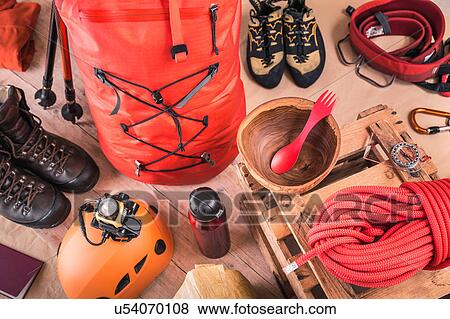 Stock Photo - Overhead view of prepared climbing equipment with rucksack, climbing boots and climbing rope. Fotosearch