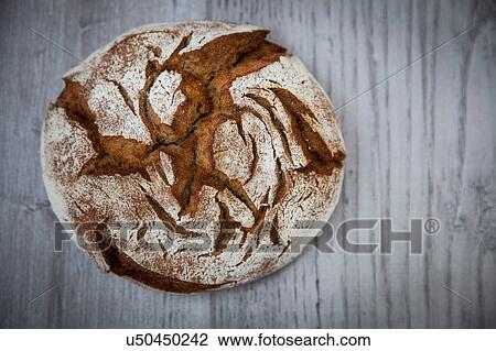 Stock Image - Overhead view of Rye bread (Roggenbrot) on table. Fotosearch