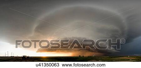 Panoramic view of a tornado-producing supercell thunderstorm spinning over ranch land at sunset near Leoti, Kansas View Large Photo Image Stock Image - Panoramic view of a tornado-producing supercell thunderstorm spinning over ranch land at sunset near Leoti, Kansas. Fotosearch