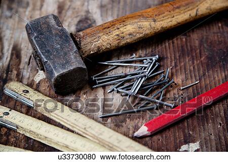 Stock Image - Pencil, nails, hammer, zig zag ruler. Fotosearch
