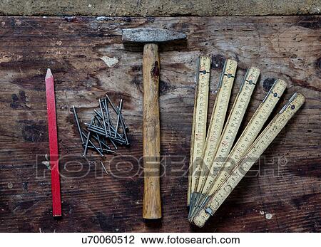 Stock Image - Pencil, nails, hammer, zig zag ruler. Fotosearch