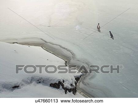 Stock Image - Penguins on frozen lake. Fotosearch