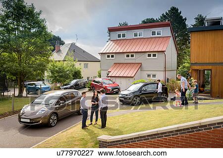 Stock Photo - People in neighbourhood with electric cars. Fotosearch