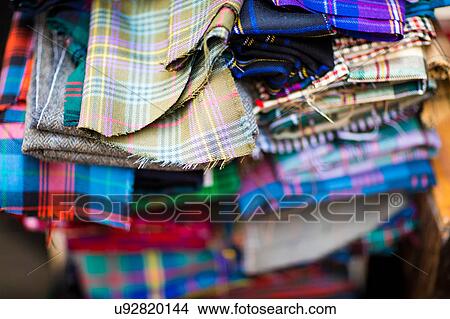 Picture - Pile of patterned fabric in leather jacket manufacturers, close-up. Fotosearch