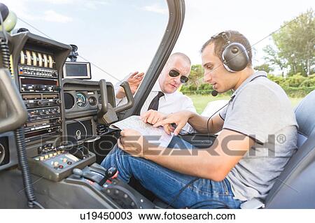 Pilot and co-pilot talking through flight plan View Large Photo Image Stock Image - Pilot and co-pilot talking through flight plan. Fotosearch