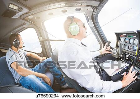 Picture - Pilot and passenger in small aircraft. Fotosearch