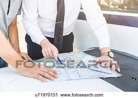Pilot explaining flight plan to aircraft passenger View Large Photo Image Stock Image - Pilot explaining flight plan to aircraft passenger. Fotosearch