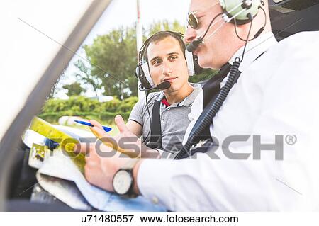 Stock Photo - Pilot explaining flight plan to aircraft passenger. Fotosearch