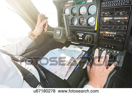 Stock Photo - Pilot in cockpit of aircraft, in flight. Fotosearch