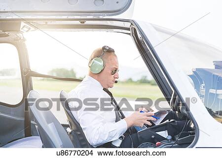 Pilot in cockpit of aircraft View Large Photo Image Picture - Pilot in cockpit of aircraft. Fotosearch