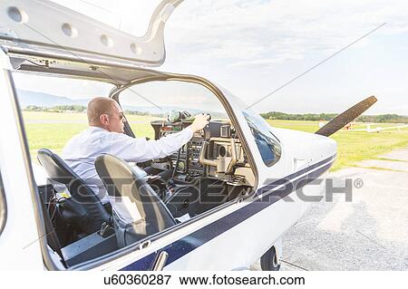 Pilot in cockpit of aircraft View Large Photo Image Stock Photo - Pilot in cockpit of aircraft. Fotosearch