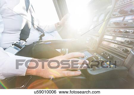 Stock Photograph - Pilot in cockpit of aircraft. Fotosearch