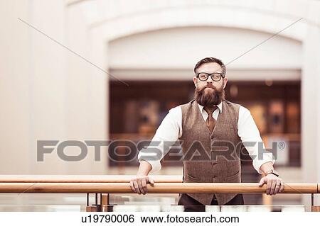 Portrait of bearded businessman wearing tweed waistcoat on office balcony View Large Photo Image Stock Photograph - Portrait of bearded businessman wearing tweed waistcoat on office balcony. Fotosearch