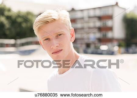 Stock Photography - Portrait of blond young male skateboarder in skatepark. Fotosearch