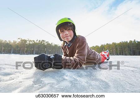 Portrait of boy lying on his front on frozen lake, Gavle, Sweden View Large Photo Image Stock Photo - Portrait of boy lying on his front on frozen lake, Gavle, Sweden. Fotosearch