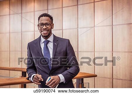 Picture - Portrait of businessman on office balcony. Fotosearch