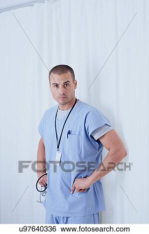Stock Photograph - Portrait of confident male doctor in hospital ward. Fotosearch