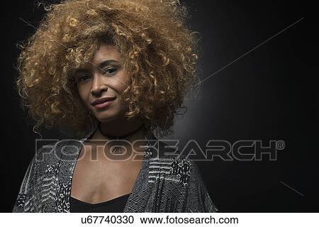 Portrait of cool blond woman on black background View Large Photo Image Stock Image - Portrait of cool blond woman on black background. Fotosearch