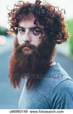 Stock Photo - Portrait of curly haired, bearded young male hipster. Fotosearch