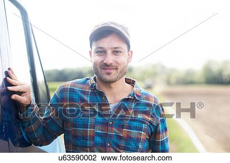 Portrait of farmer looking at camera smiling View Large Photo Image Stock Image - Portrait of farmer looking at camera smiling. Fotosearch