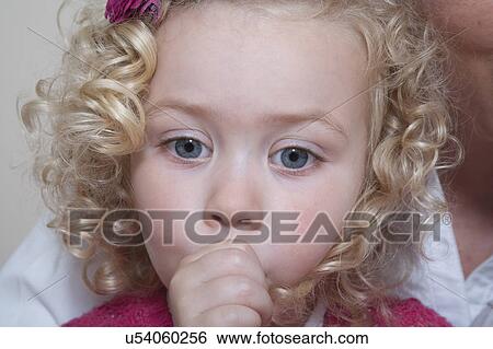 Portrait of girl (4-5) sucking thumb View Large Photo Image Stock Photograph - Portrait of girl (4-5) sucking thumb. Fotosearch