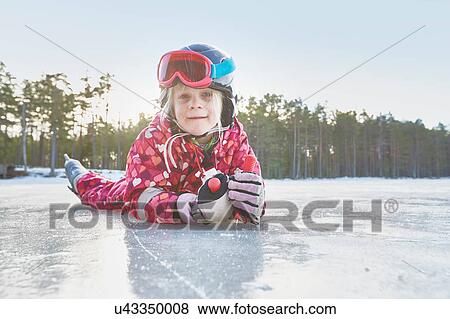 Portrait of girl lying on her front on frozen lake, Gavle, Sweden View Large Photo Image Stock Photo - Portrait of girl lying on her front on frozen lake, Gavle, Sweden. Fotosearch