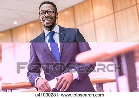 Portrait of happy businessman on office balcony View Large Photo Image Stock Image - Portrait of happy businessman on office balcony. Fotosearch