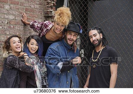 Portrait of happy friends against brick wall View Large Photo Image Stock Photograph - Portrait of happy friends against brick wall. Fotosearch