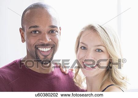 Stock Image - Portrait of happy multi ethnic couple. Fotosearch