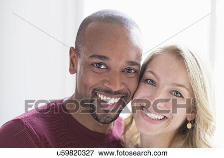 Portrait of happy multi ethnic couple View Large Photo Image Stock Photo - Portrait of happy multi ethnic couple. Fotosearch