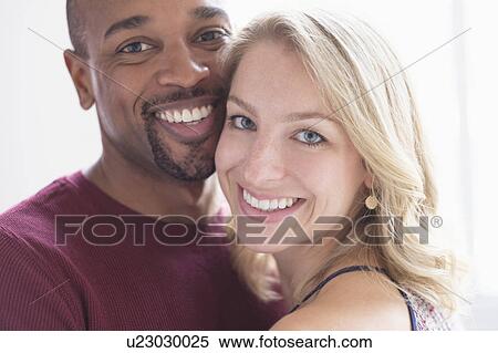 Stock Photography - Portrait of happy multi ethnic couple. Fotosearch