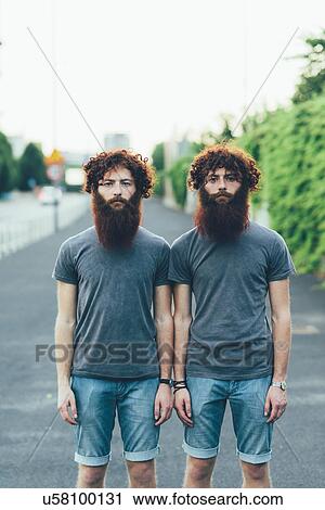 Portrait of identical adult male twins with red hair and beards on sidewalk View Large Photo Image Stock Image - Portrait of identical adult male twins with red hair and beards on sidewalk. Fotosearch