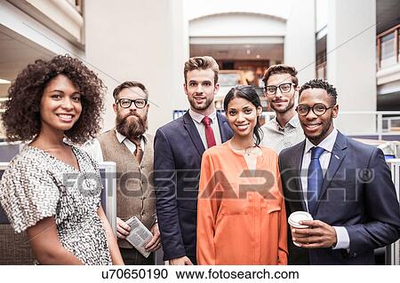 Stock Image - Portrait of male and female business team in office. Fotosearch