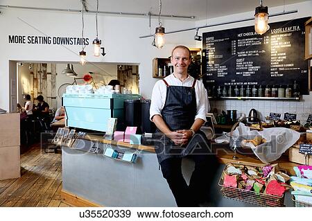 Portrait of male business owner sitting on counter of independent coffee shop View Large Photo Image Stock Photo - Portrait of male business owner sitting on counter of independent coffee shop. Fotosearch