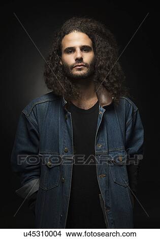 Picture - Portrait of man in denim jacket on black background. Fotosearch